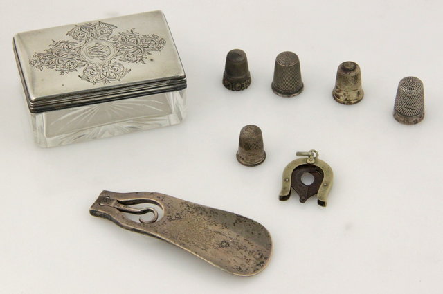 A cut glass trinket box with silver