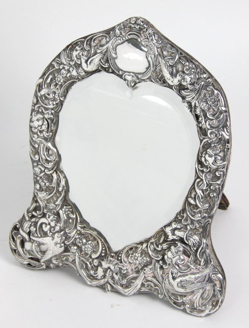 A silver framed heart shaped easel