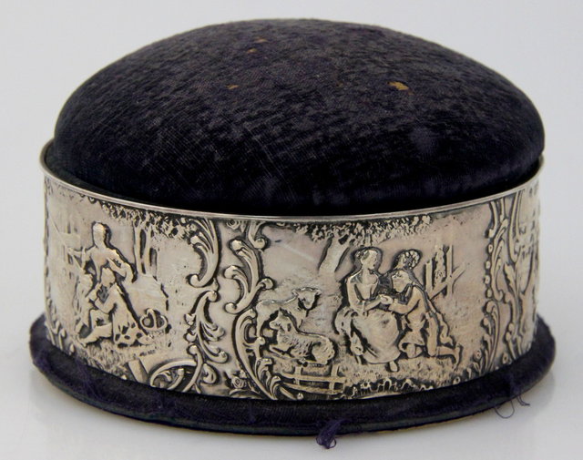 A circular silver pin cushion sewing 161738