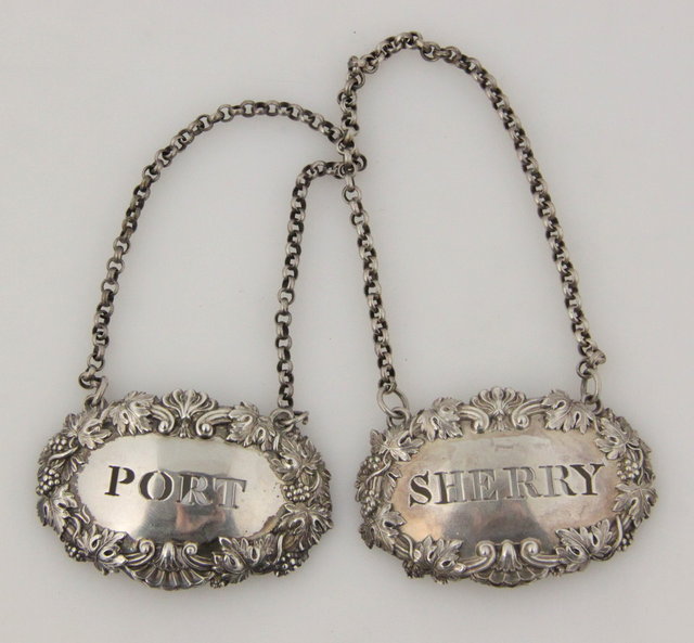 Two silver wine labels each with