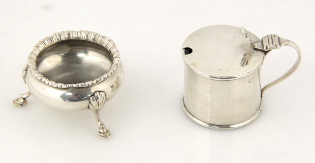 A silver cylindrical mustard pot