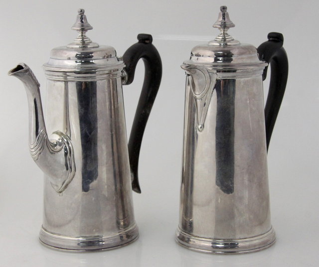 A silver coffee pot and hot water