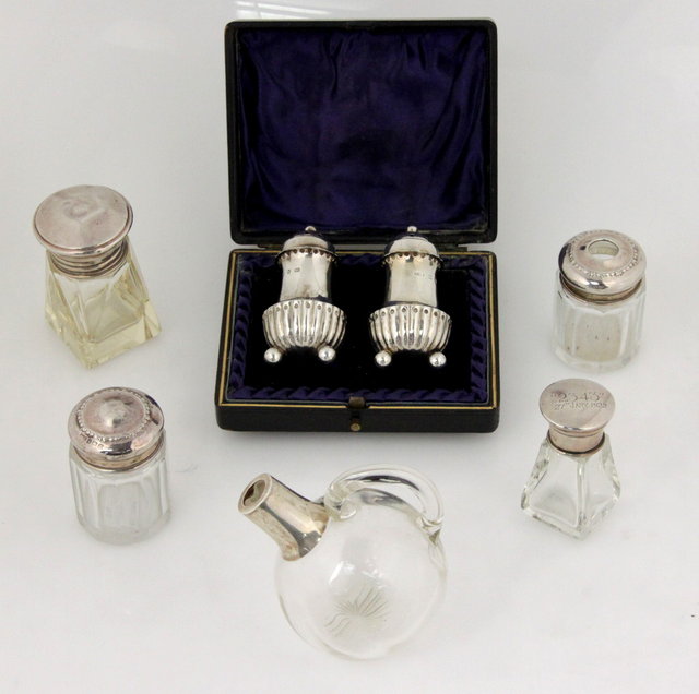 A pair of silver pepper pots H T 161762