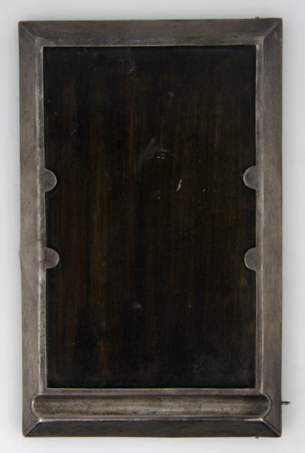 A silver framed notepad holder