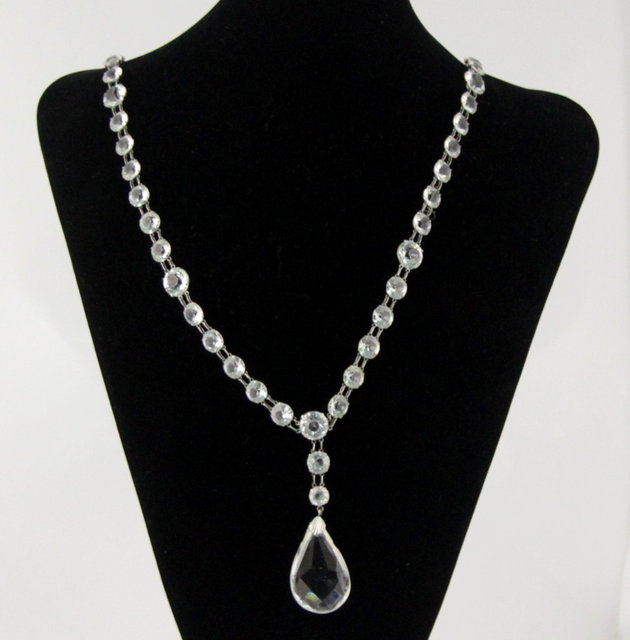 A glass necklace with pear shaped
