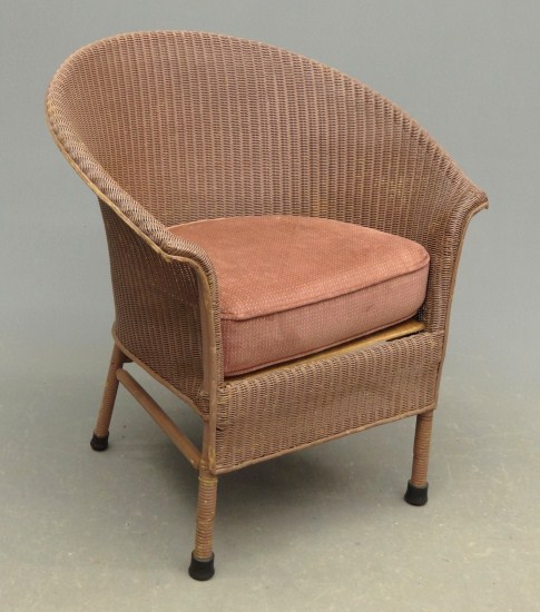 Vintage wicker chair in brown paint.