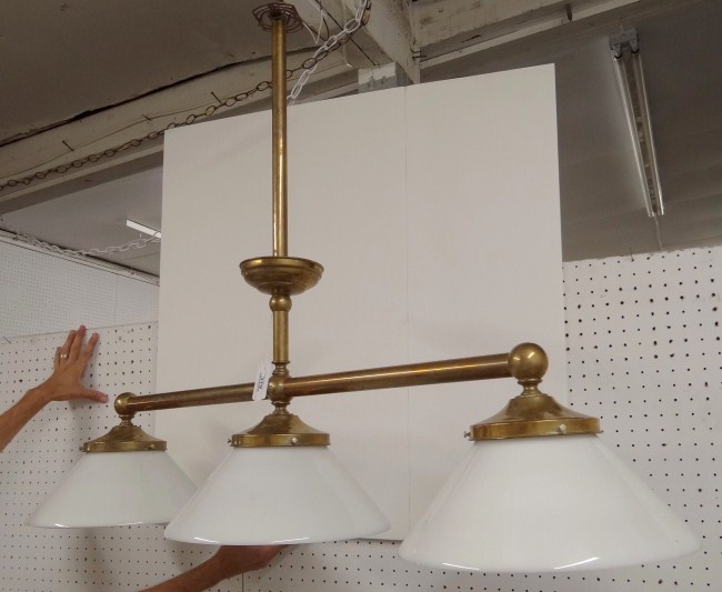 Hanging brass lamp with three globes.