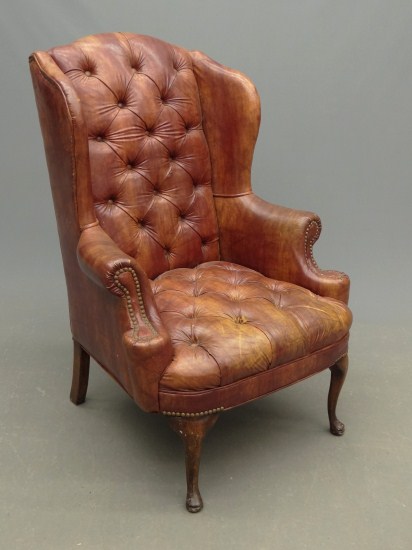Tufted leather style wing chair.