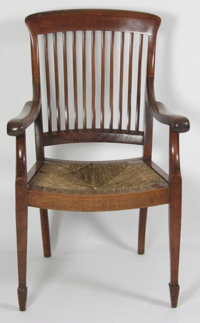 An Edwardian armchair with rush seat