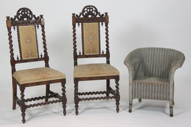 A pair of Edwardian oak hall chairs