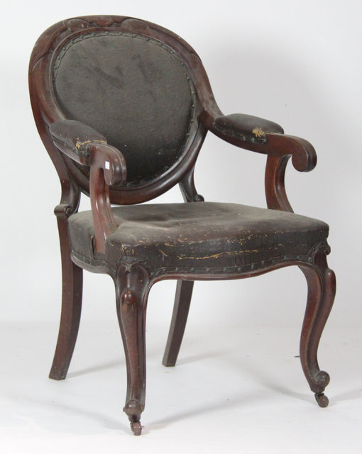 A Victorian open armchair the arch