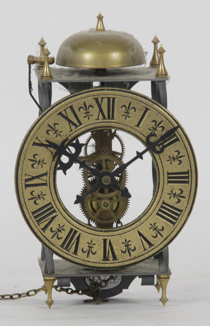 A bracket clock with brass chapter