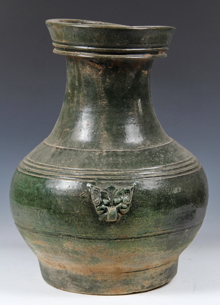 A LARGE GREEN-GLAZED POTTERY JAR