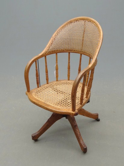 C. 1900 s oak swivel desk chair.