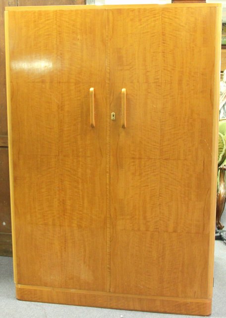 A satin birch wardrobe with matched