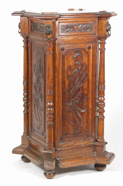 A Victorian carved oak pedestal
