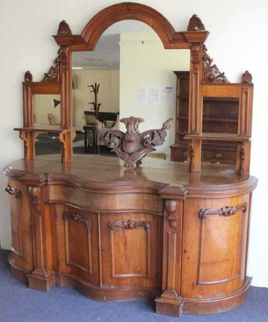 A Victorian oak serpentine front sideboard