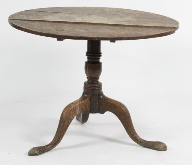 A George III oak tripod table with 16470a