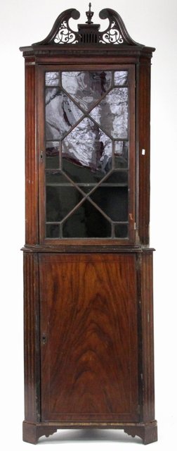 A mahogany corner cupboard in two