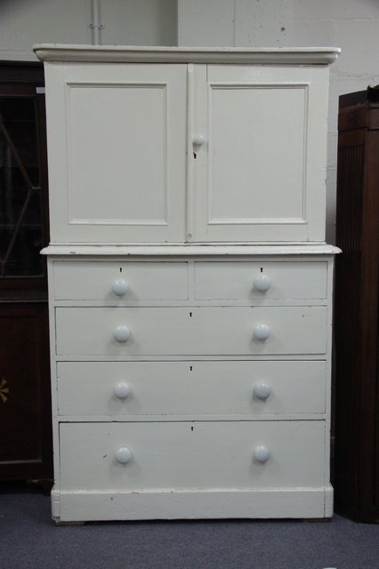 A white painted pine cupboard enclosed