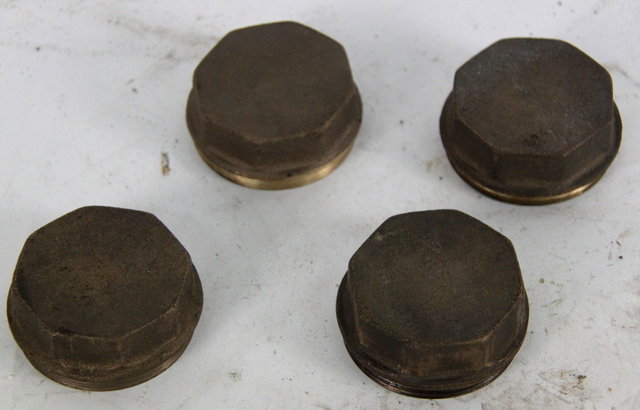 Four octagonal brass hub nuts from