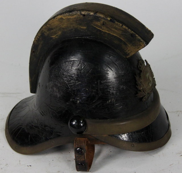 A fireman s leather helmet with 162232