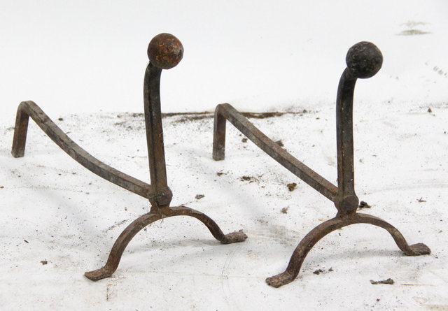 A pair of fire dogs with ball finials