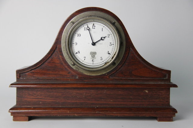 A Smiths car clock mounted in an oak
