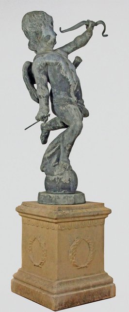 A lead figure of Cupid a bow in