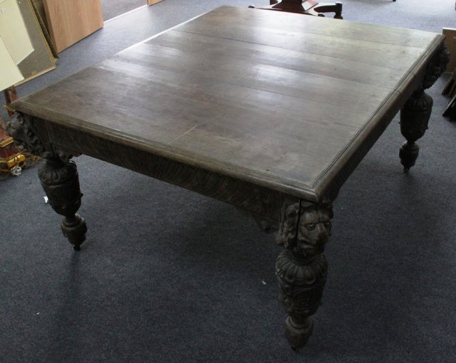 A Victorian oak dining table with carved