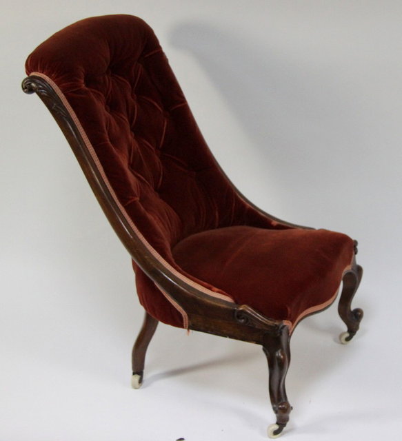 A Victorian carved and button upholstered