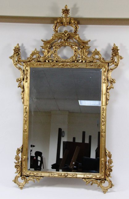 A carved gilt wood wall mirror