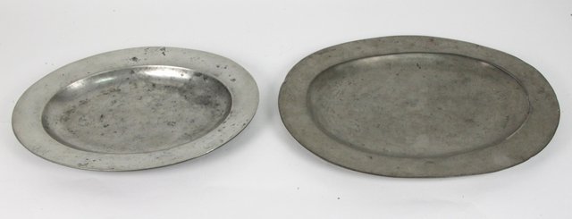 Two pewter oval platters each with plain