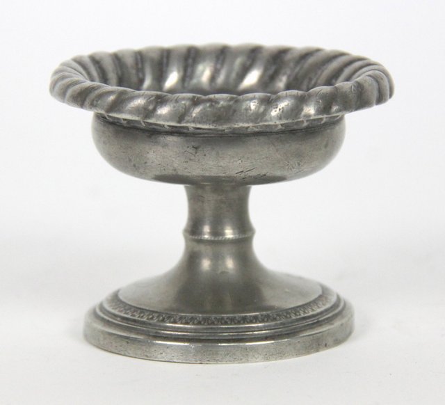 A pewter cup salt with gadrooned rim