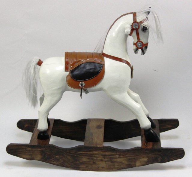 A wooden rocking horse on a bow rocker