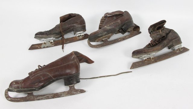 Two pairs of brown leather ice skates