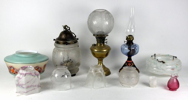 A brass oil lamp with etched glass