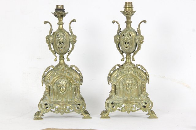 A pair of brass urn shaped lamps