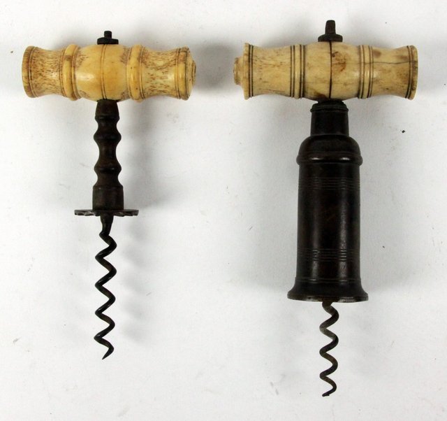 A brass corkscrew with turned ivory