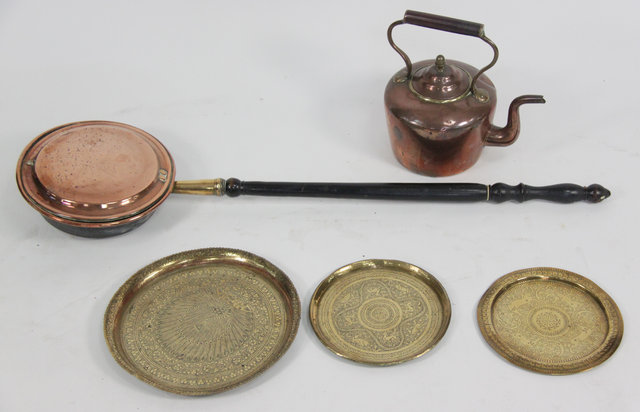 A copper warming pan with turned wood