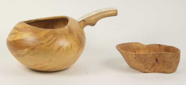 A turned wood pot the handle with