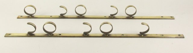 A pair of brass five-gun hanging brackets