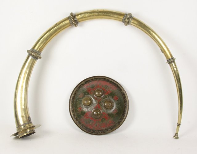 An Indian brass horn and a small shield