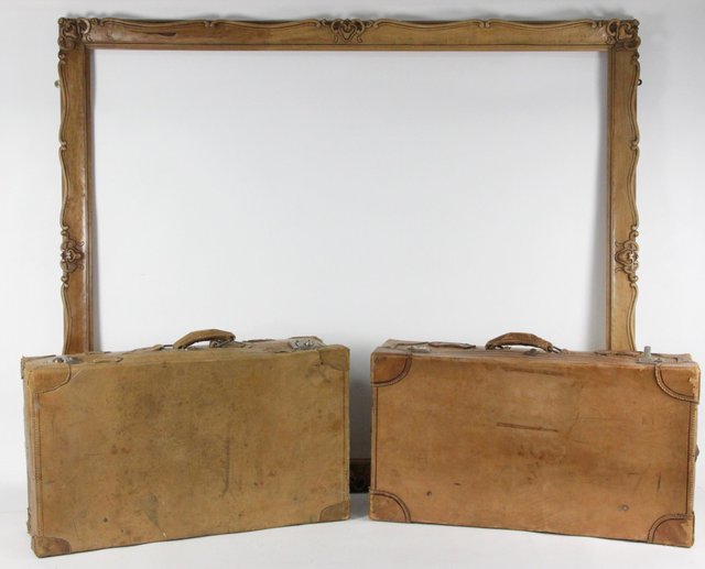 Two leather suitcases and a carved
