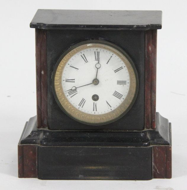 A black marble mantel clock fitted an