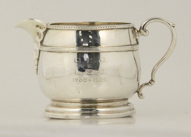 A silver cream jug Birmingham 1925