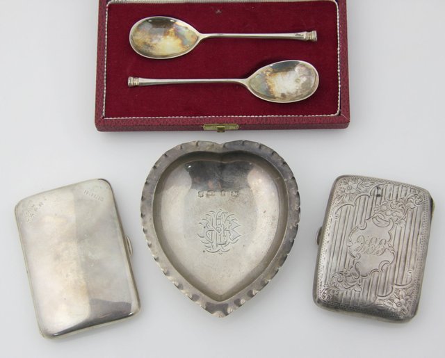 A heart-shaped silver pin tray