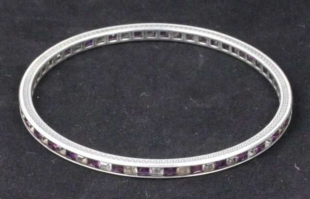 A white metal bangle channel set