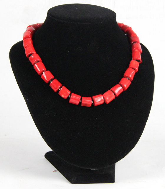 A coral necklace with silver flowerhead