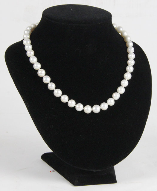 A pearl necklace the clasp marked